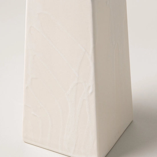 White ceramic vase on a light gray background