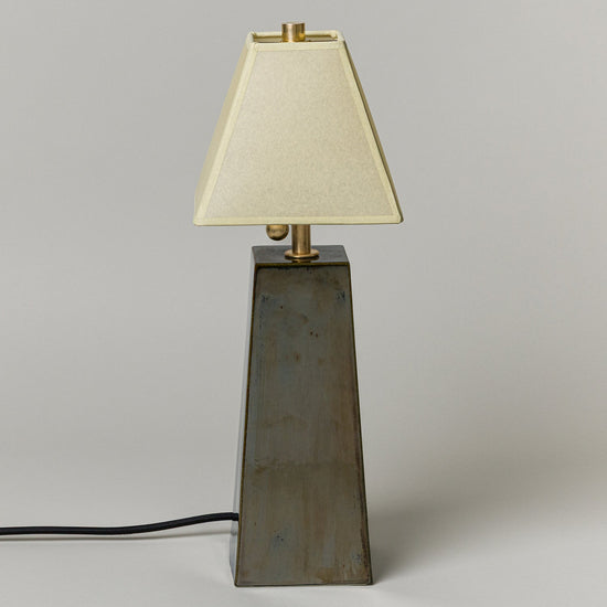 Table lamp with a beige shade on a gray background