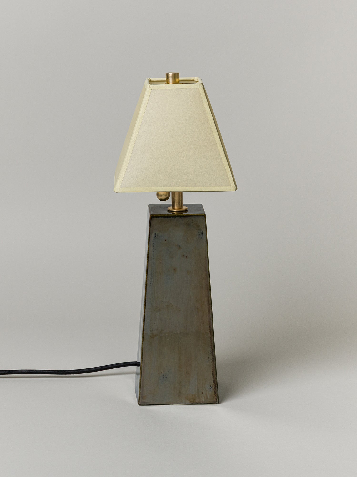 Table lamp with a beige shade on a gray background