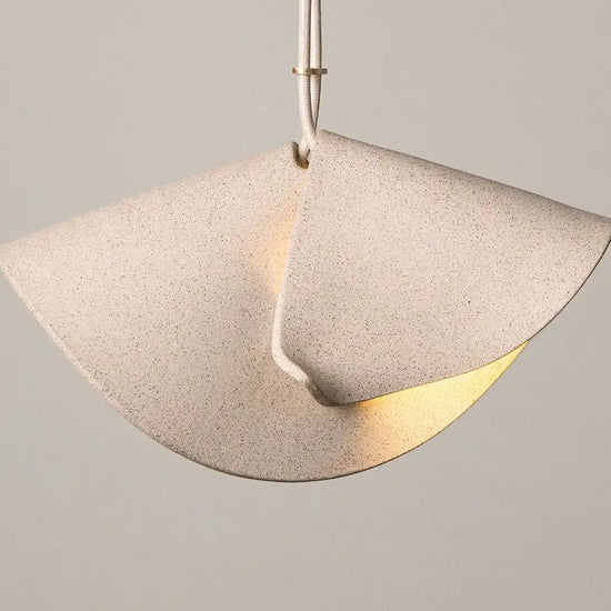 Pendant light with a concrete-like finish on a neutral background