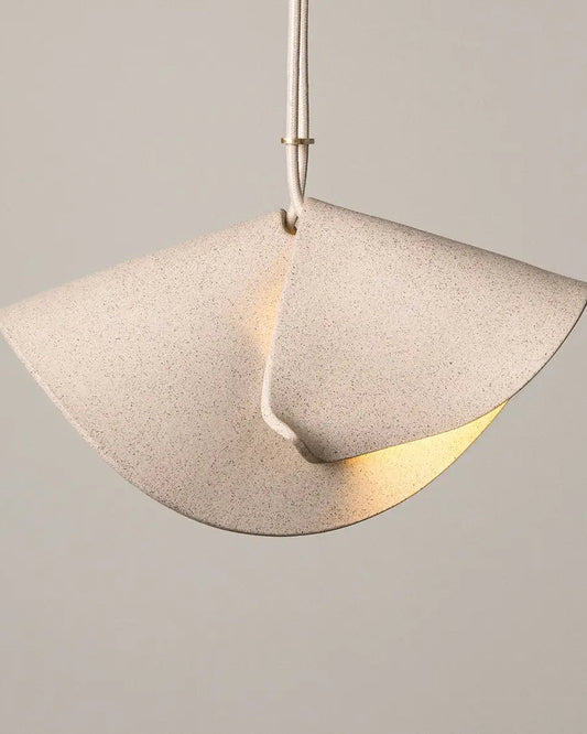 Pendant light with a concrete-like finish on a neutral background