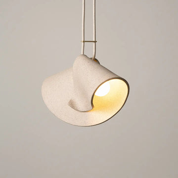 Modern pendant light with a beige shade on a neutral background
