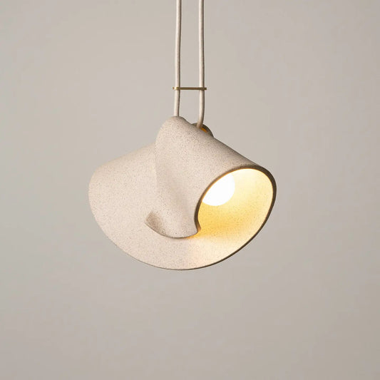 Modern pendant light with a beige shade on a neutral background