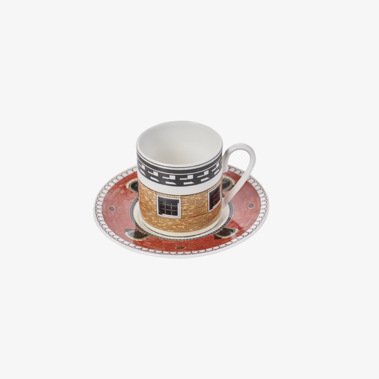Ceramic cup and saucer with decorative design on a white background