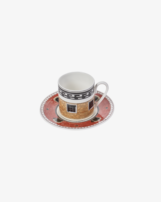 Ceramic cup and saucer with decorative design on a white background