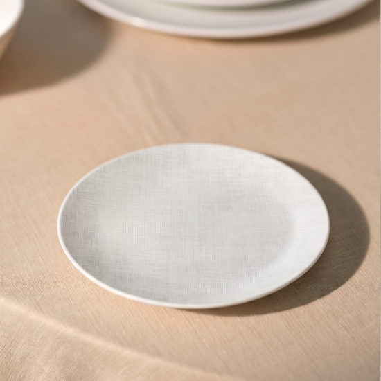 White ceramic plate on a beige surface