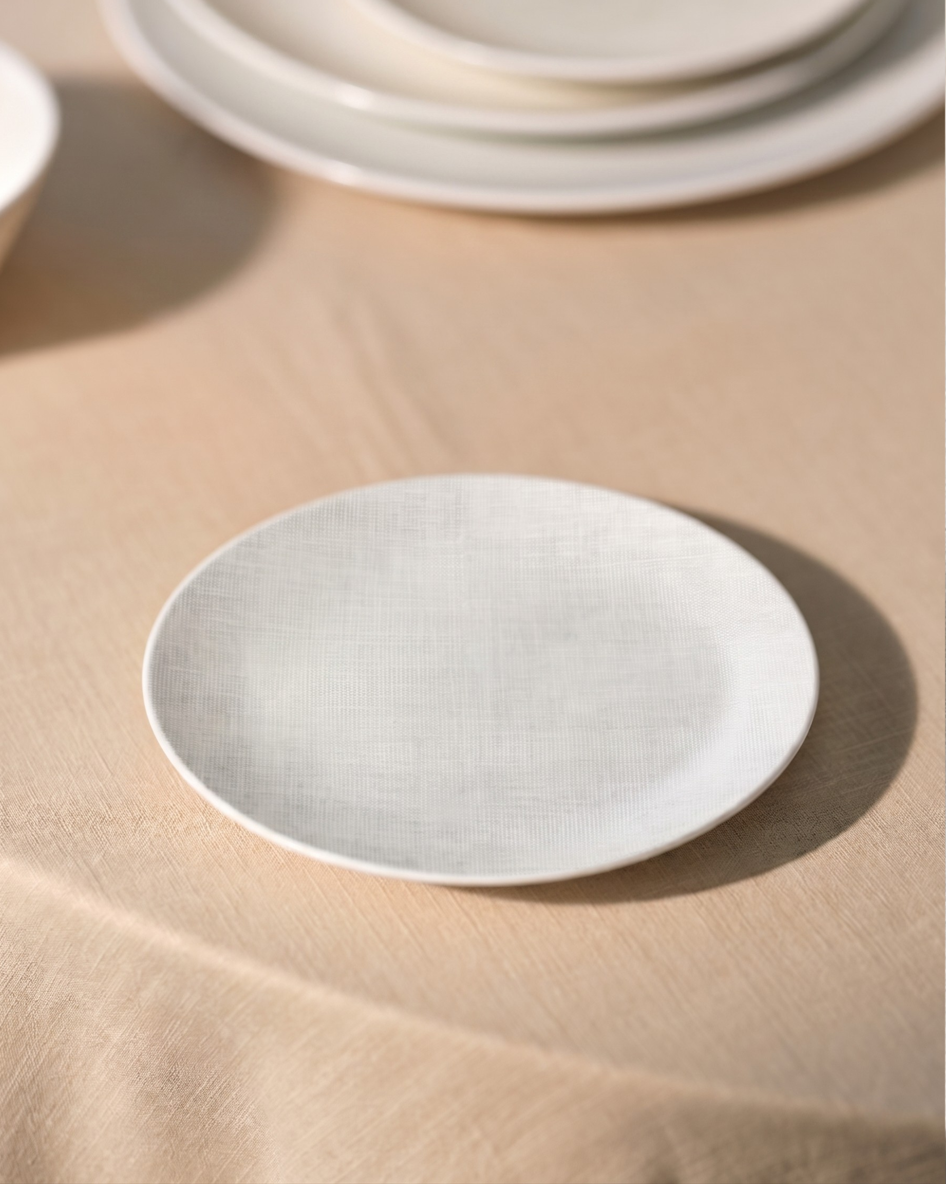 White ceramic plate on a beige surface