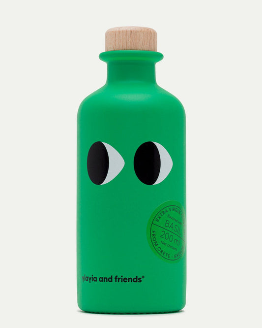 Green olive oil bottle with black and white eye design on a white background