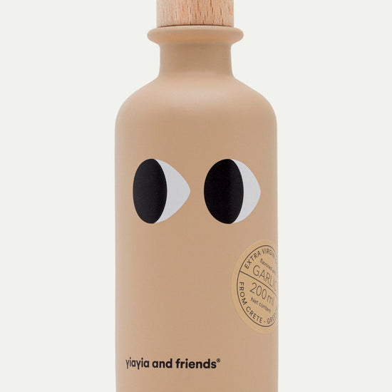 Beige olive oil bottle with black and white eyes on a white background