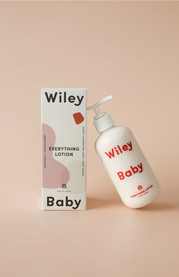 Wiley Baby lotion bottle and packaging on a beige background
