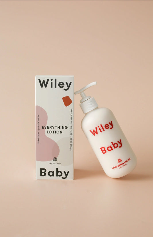 Wiley Baby lotion bottle and packaging on a beige background
