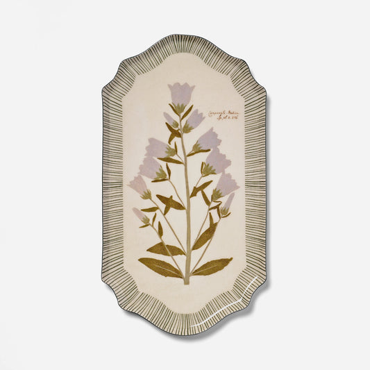 An oval decorative wall plaque or tray featuring a botanical illustration of lavender flowers and olive-green leaves on a cream background, surrounded by a scalloped striped border.
